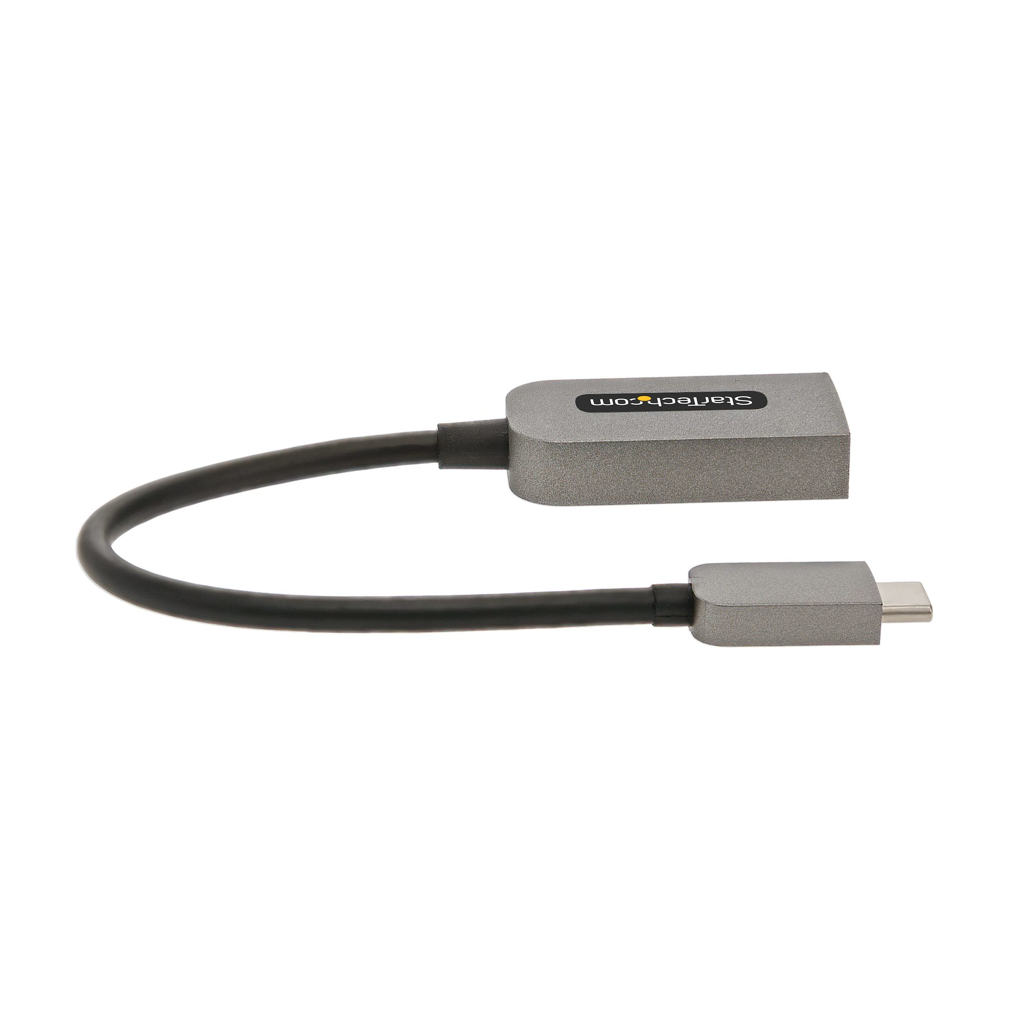 Un adaptador Startech gris con cable negro. Un extremo es USB-C, el otro un bloque gris más grande.