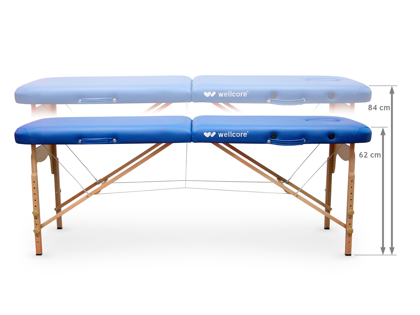 Una mesa de masaje azul, marca wellcore, con patas de madera. Se marcan las dimensiones. Una imagen descolorida de la mesa está encima.