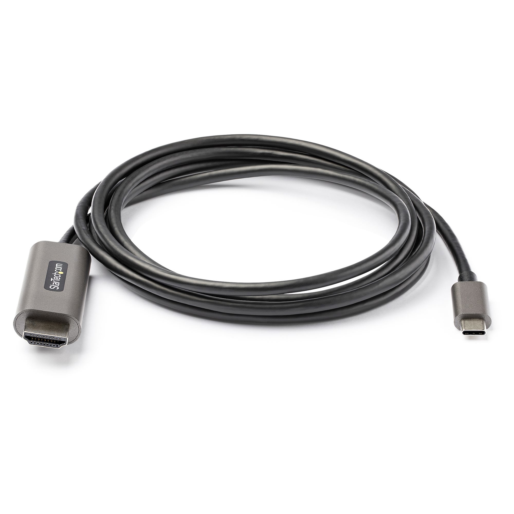 Cable gris HDMI a USB-C, enrollado sobre superficie blanca. El cable tiene conectores en ambos extremos y logo StarTech.com.