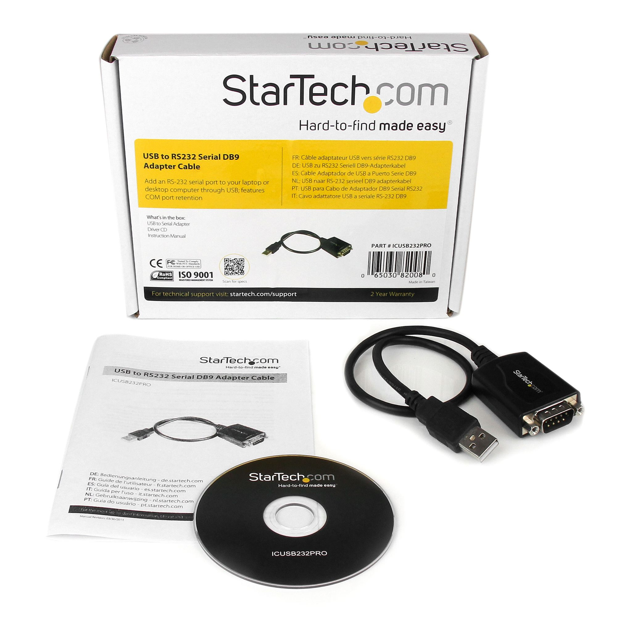 Una caja con un cable adaptador USB a RS232, un CD y un manual están sobre una superficie blanca.