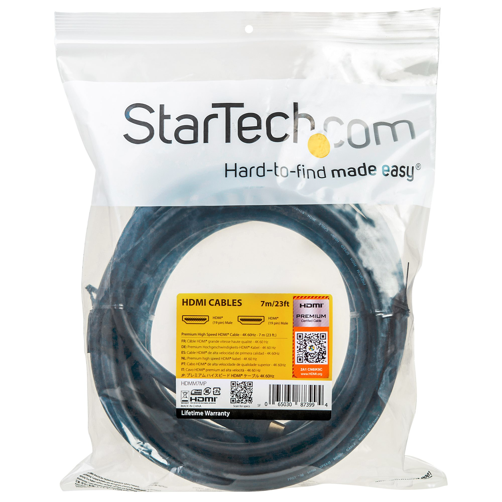 Paquete sellado de plástico transparente con cable HDMI negro. El paquete tiene una etiqueta amarilla con texto y logotipos.