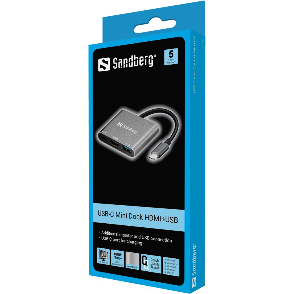 Die Box zeigt ein Sandberg USB-C Mini Dock HDMI+USB. Es ist silbern, mit einem schwarzen Kabel. Merkmale: Monitoranschluss, USB-C-Aufladung.