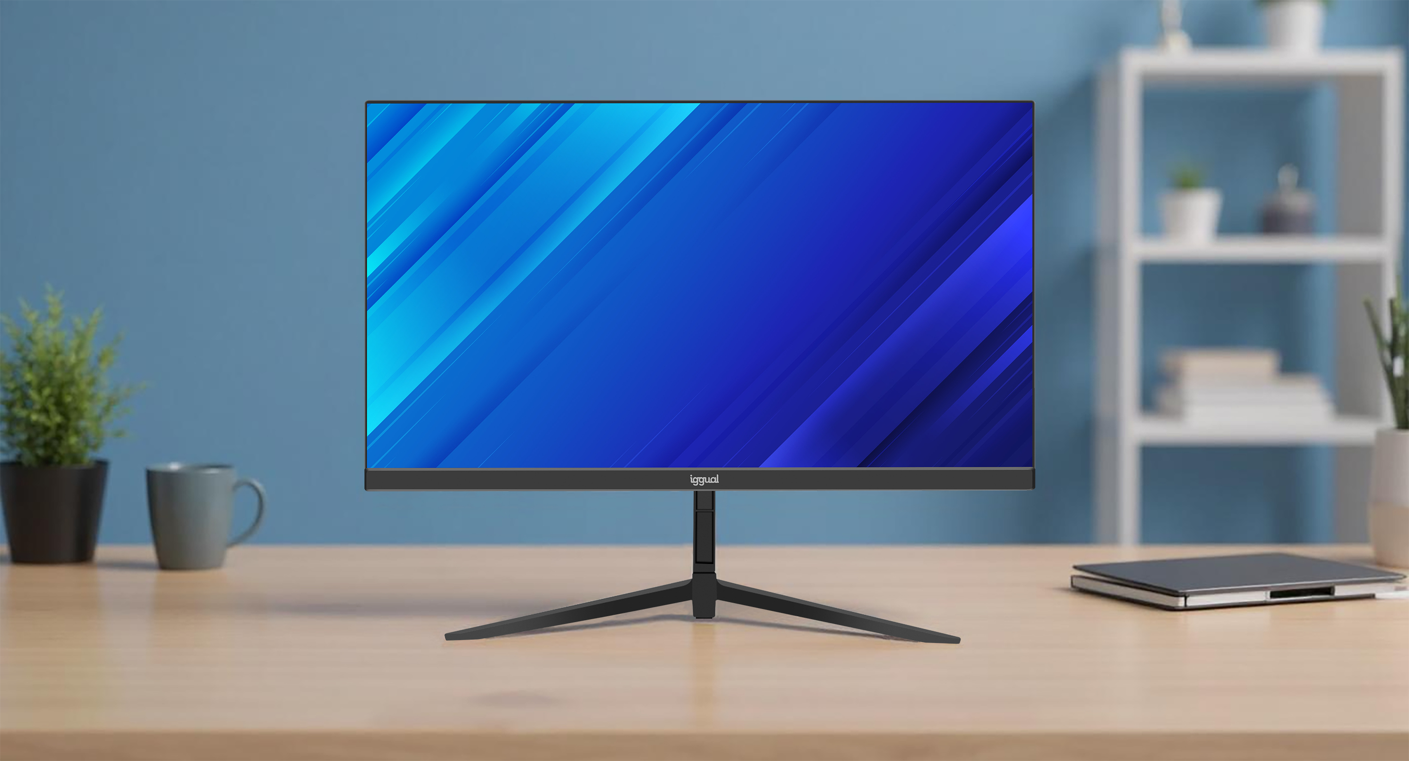 A computer monitor with a blue gradient screen sits on a wooden desk. A plant and a mug are on the left. Shelves in the background.