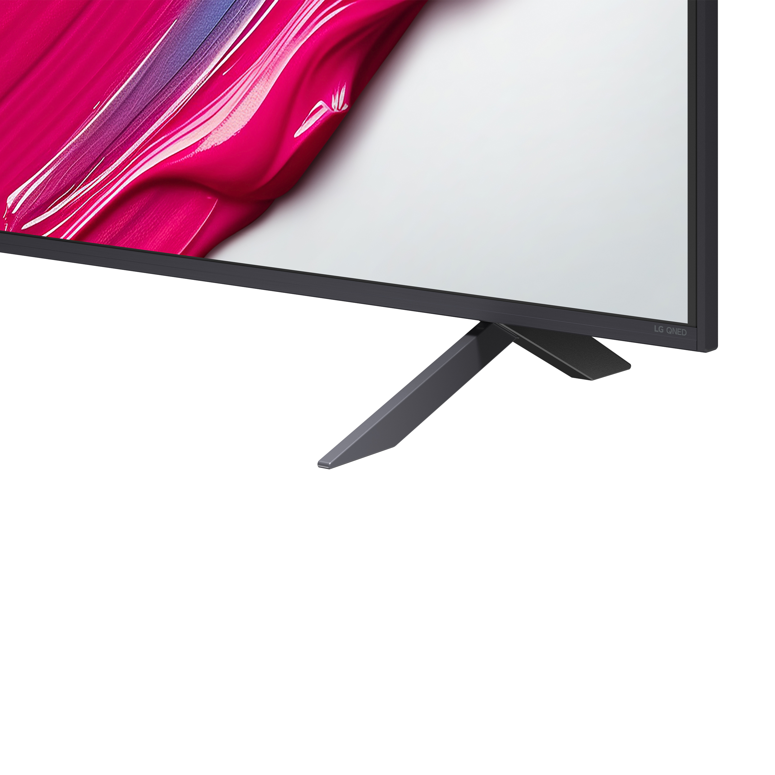 Zbliżenie telewizora. Ekran pokazuje pociągnięcia różową i białą farbą. Telewizor ma czarną podstawę.