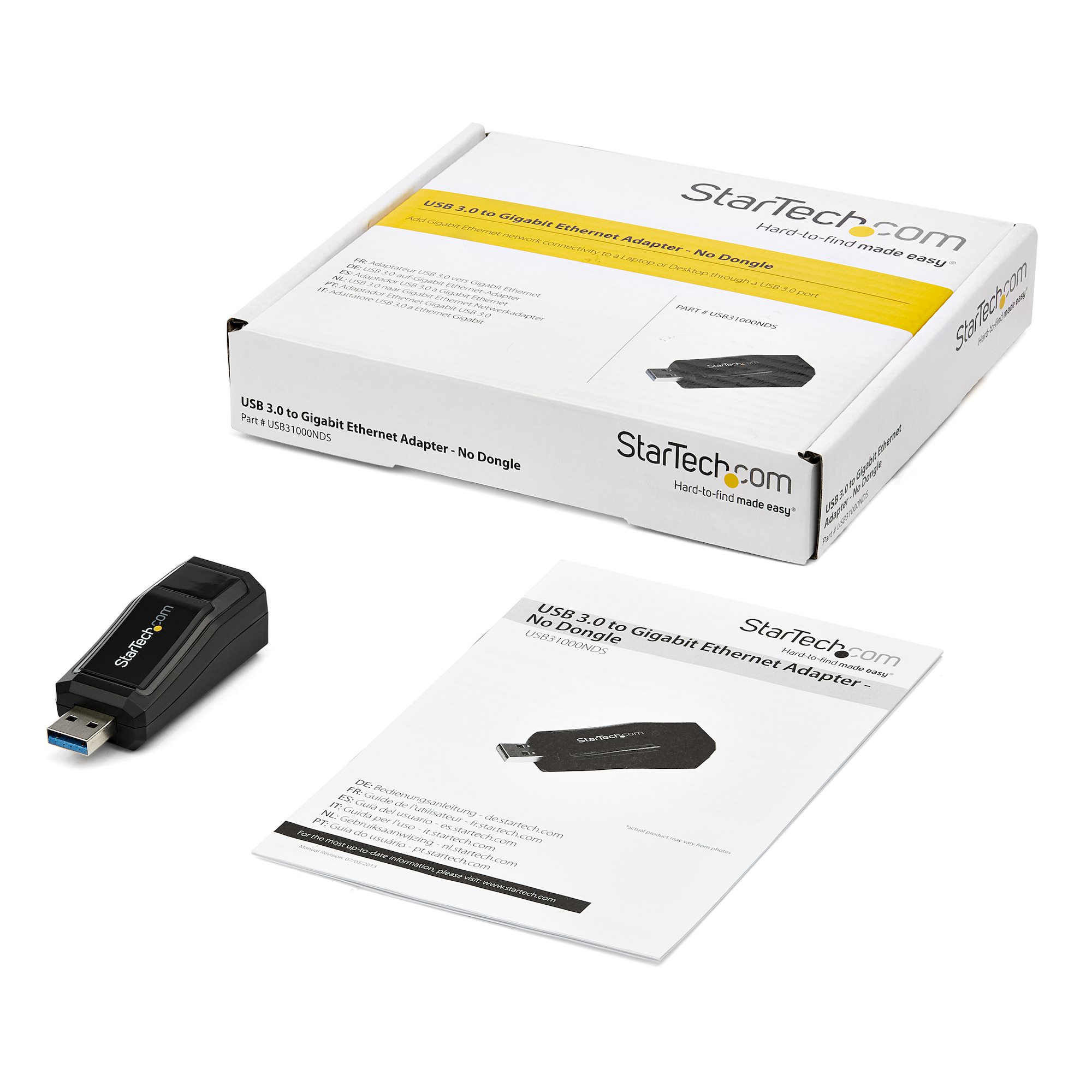 Una caja con un adaptador USB 3.0 a Gigabit Ethernet, un adaptador negro e instrucciones son visibles.