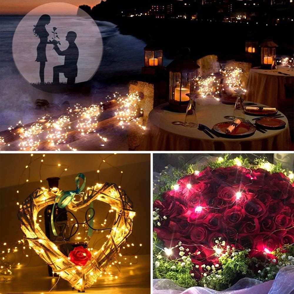 Romantische Szene: Paarsilhouette, Esstisch, herzförmige Dekoration und roter Rosenstrauß. Beleuchtet mit Lichterketten.