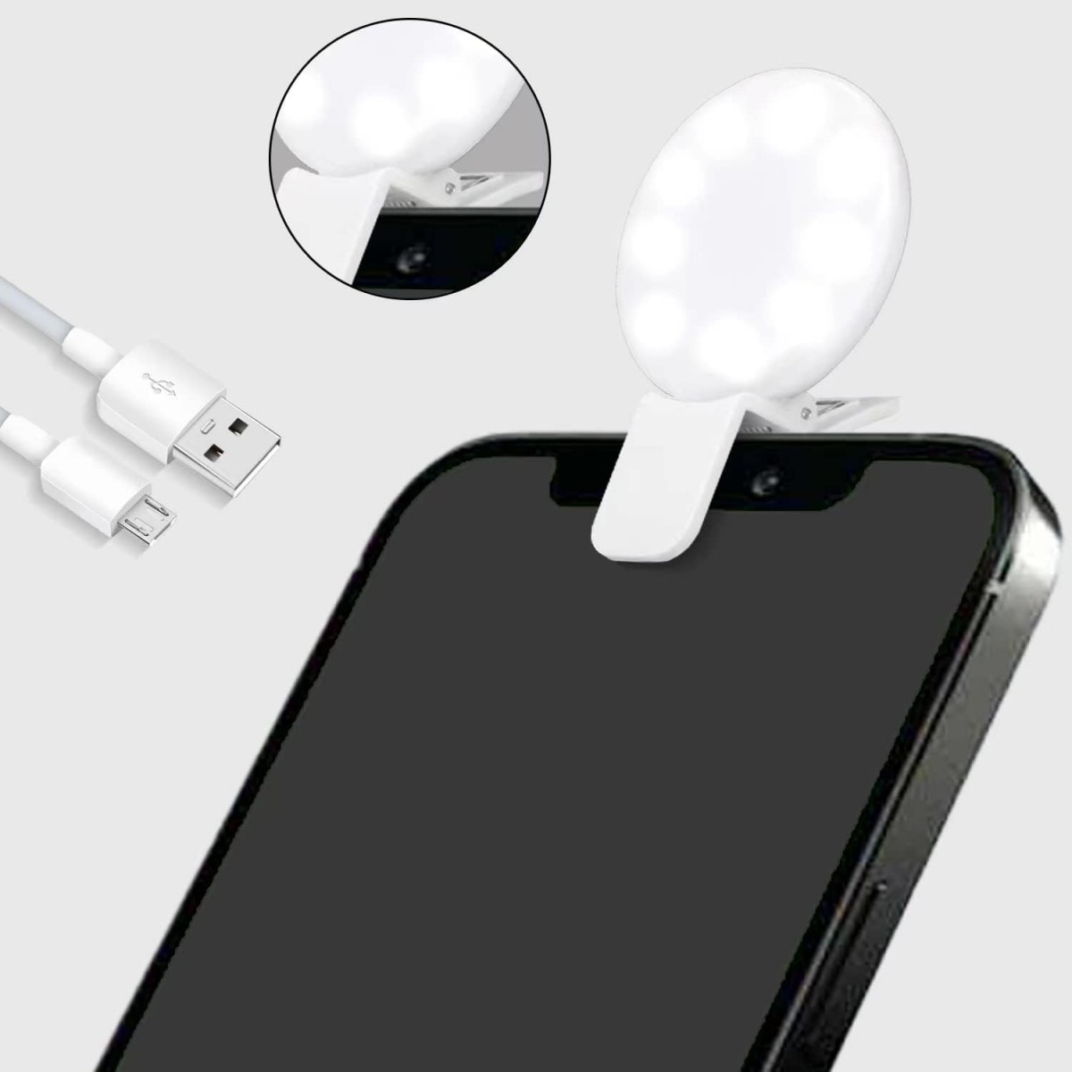 Ein weißes LED-Selfie-Licht, das an einem schwarzen Telefon befestigt ist. Ein USB-Kabel ist angeschlossen. Das Licht hat mehrere LEDs.