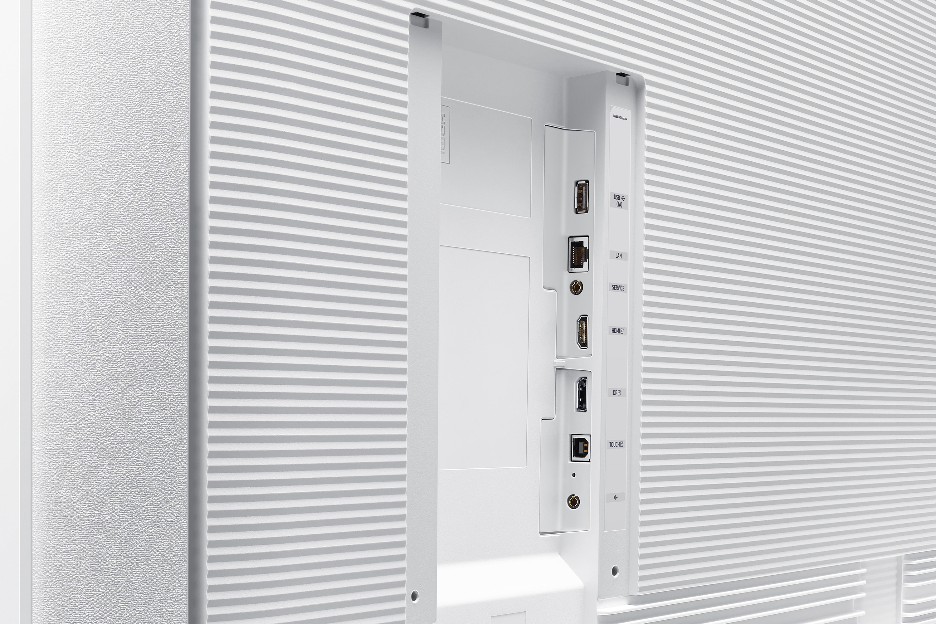 Close-up of a white TV back panel with ports for USB, HDMI, LAN, and other connections. The panel has a textured surface.