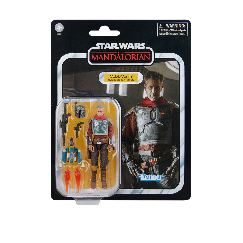 Una action figure di Star Wars Mandalorian di Cobb Vanth in confezione. Include figura, armi, casco e jetpack. Lo sfondo mostra Vanth.