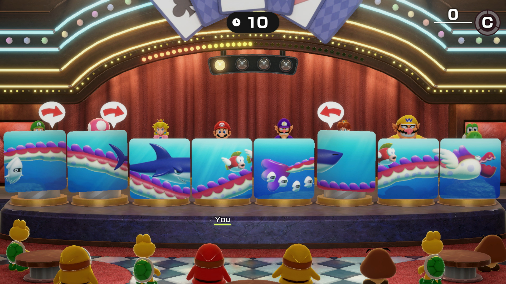 Eine Spielbühne mit Charakteren von Mario. Zu den Anzeigen gehören Haie, Fische und andere Meereskreaturen. Charaktere wie Mario und Peach sind vorhanden.