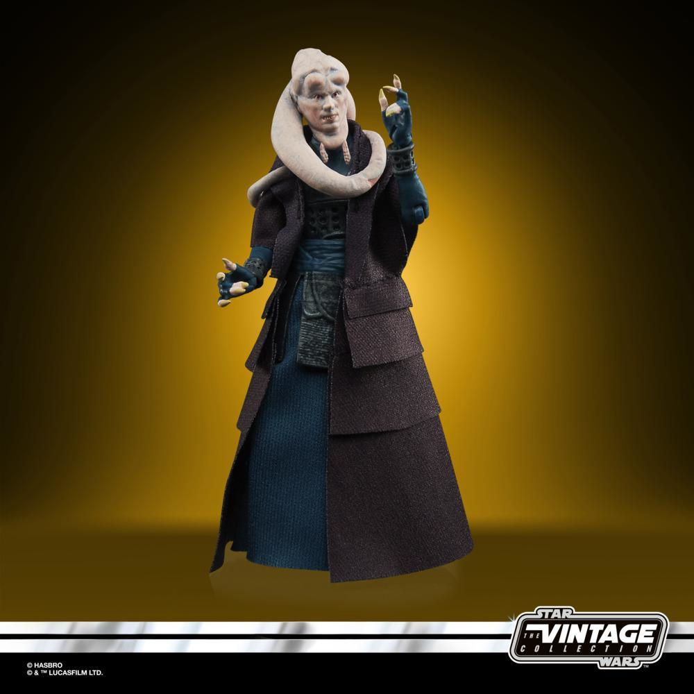 Una statuetta di Star Wars di una Twi'lek femminile. Indossa un lungo cappotto nero e un vestito blu. I suoi tentacoli sono bianchi e ha le mani aperte.