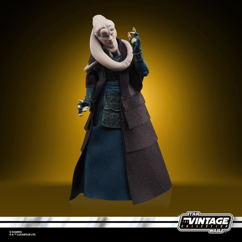 Una figura di Star Wars di un personaggio Twi'lek con un lungo cappotto nero e un vestito blu, su sfondo giallo.
