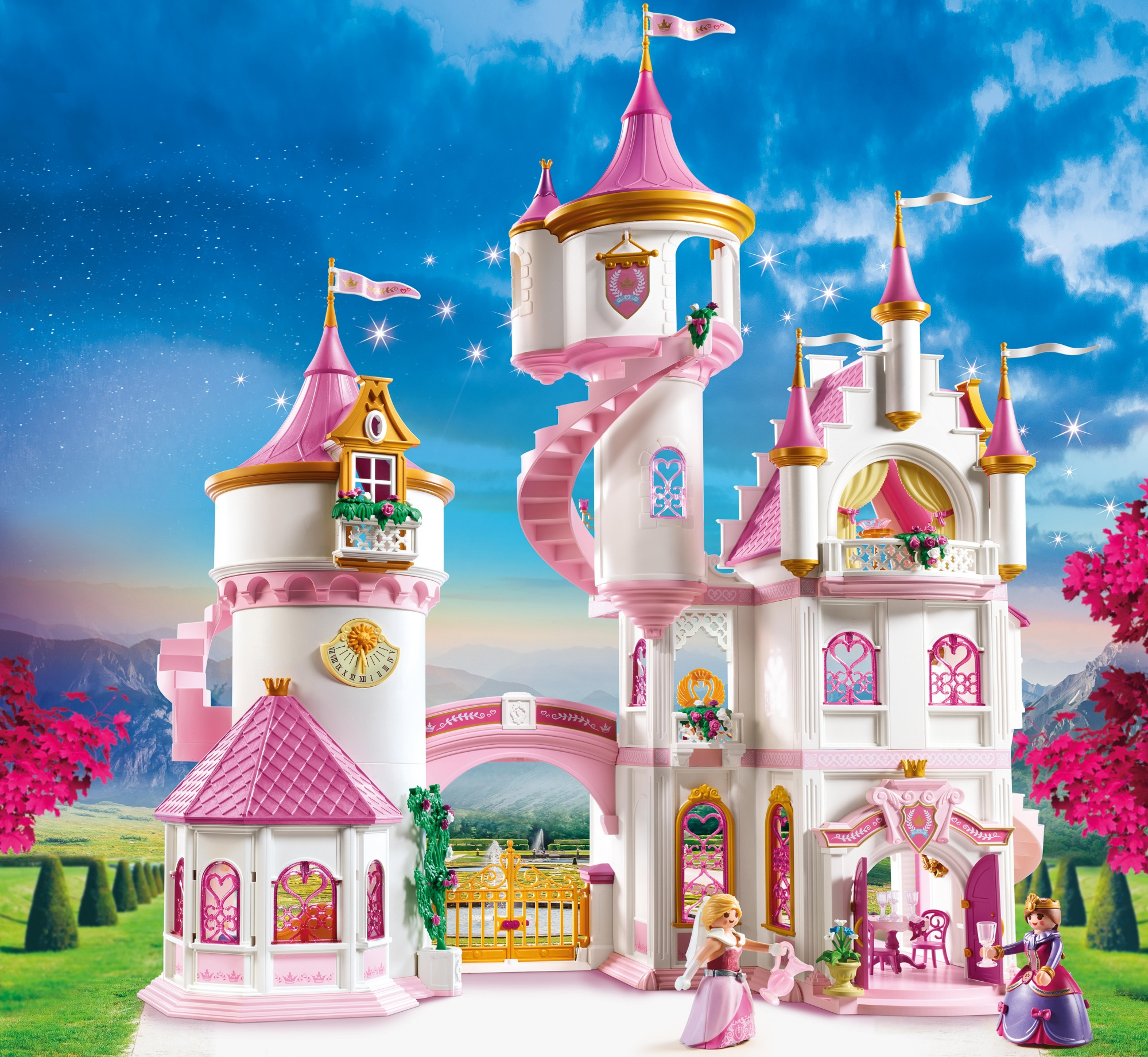 Ein Spielzeug-Prinzessinnenschloss, weiß und rosa, mit Figuren. Blauer Himmel im Hintergrund.