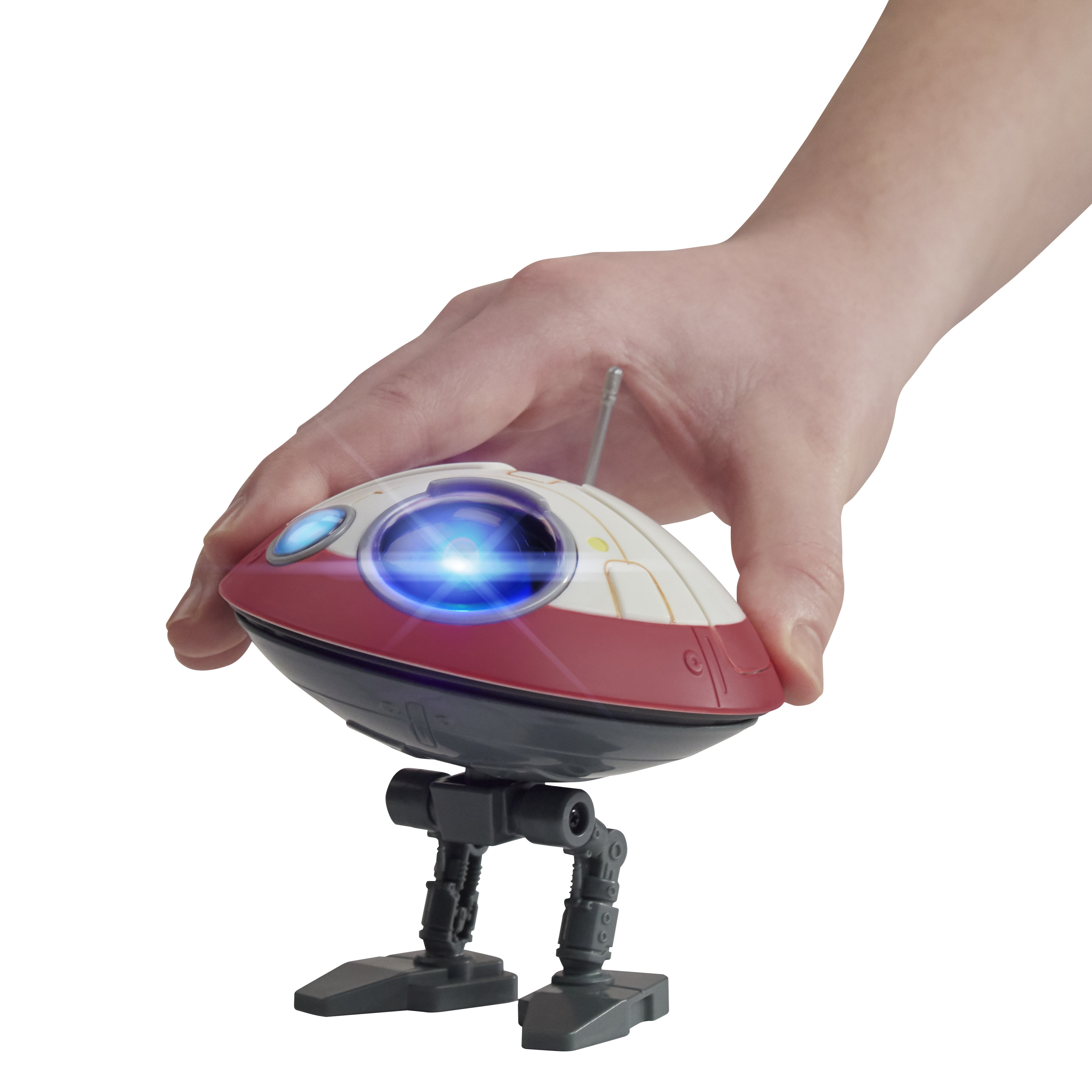 Una mano tiene in mano un robot giocattolo. Il robot è bianco e rosso, con una luce blu. Ha due gambe e una piccola antenna.
