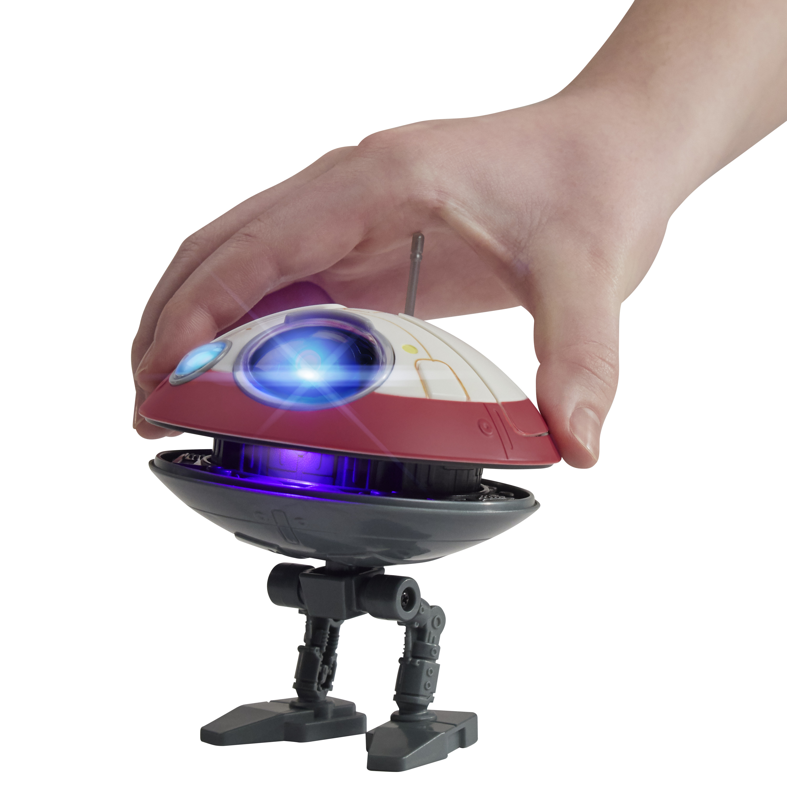 Una mano tiene un robot giocattolo. Il robot è bianco e rosso, con una luce blu. Ha due gambe.