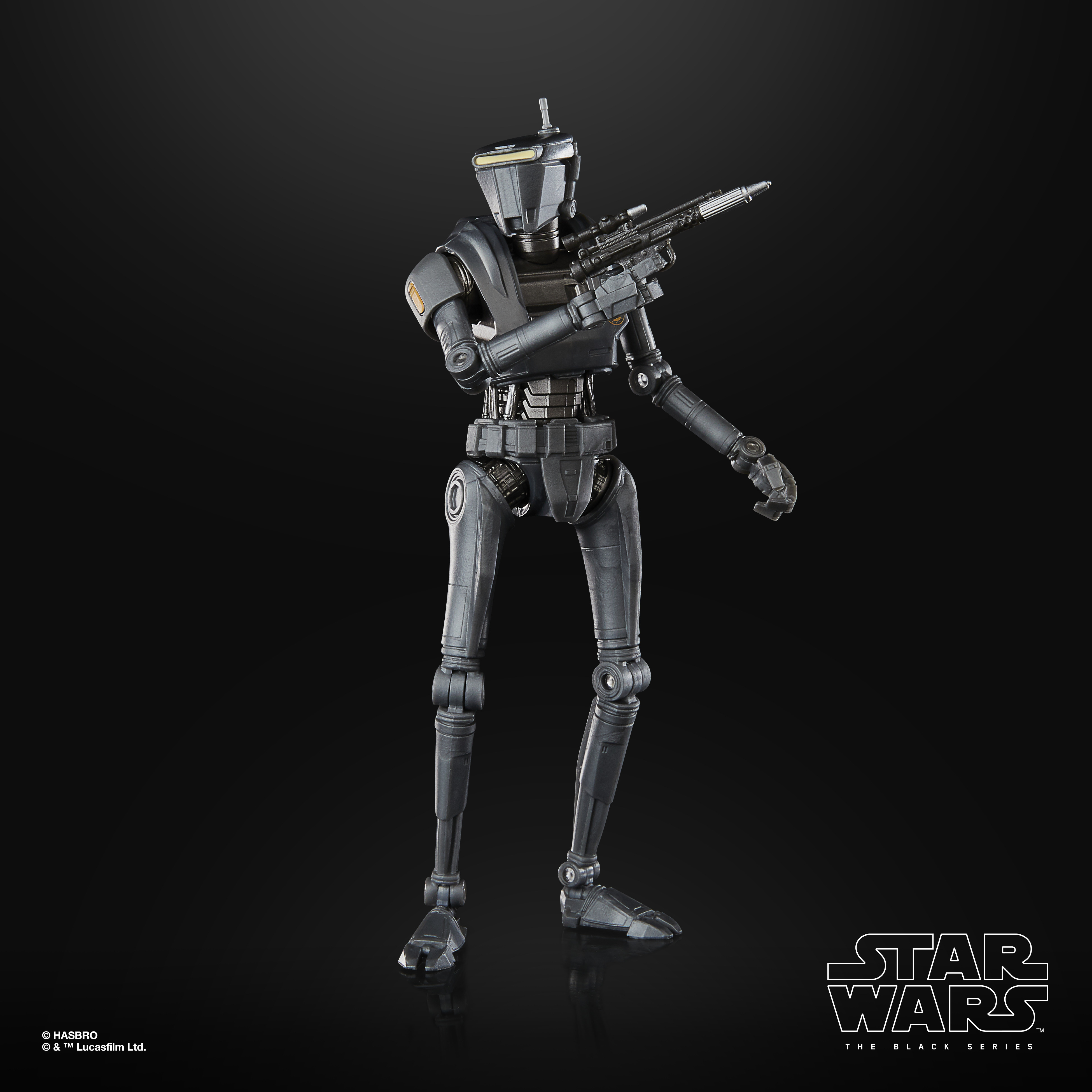 Una figura di robot grigio, che tiene una pistola. Ha uno sfondo nero. La figura è di Star Wars: The Black Series.