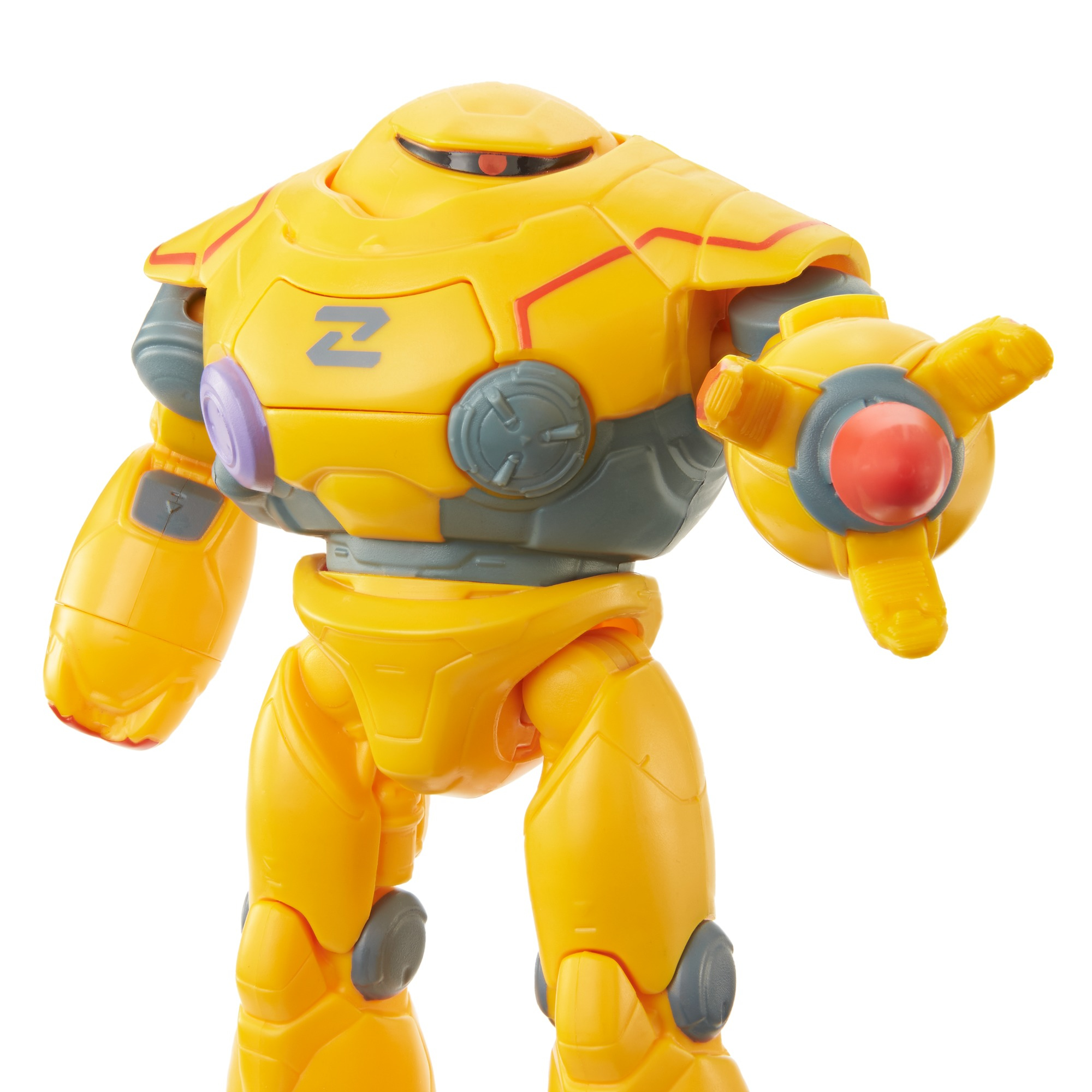 Giocattolo robot giallo con dettagli rossi e grigi. Ha un logo Z e un occhio rosso. Il robot posa con la mano aperta.