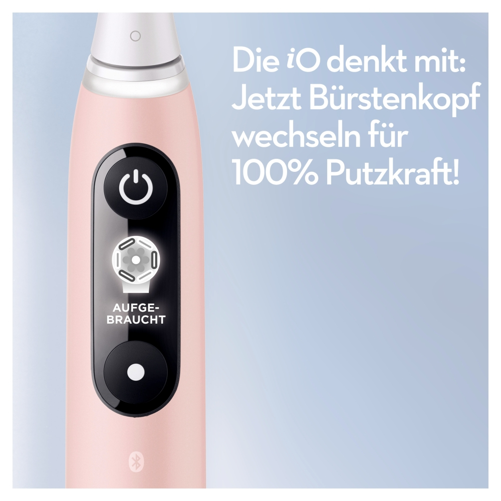 Eine rosa elektrische Zahnbürste mit schwarzen Knöpfen und einer abgenutzten Bürstenkopfanzeige. Text: 'Bürstenkopf wechseln für 100% Putzkraft!'