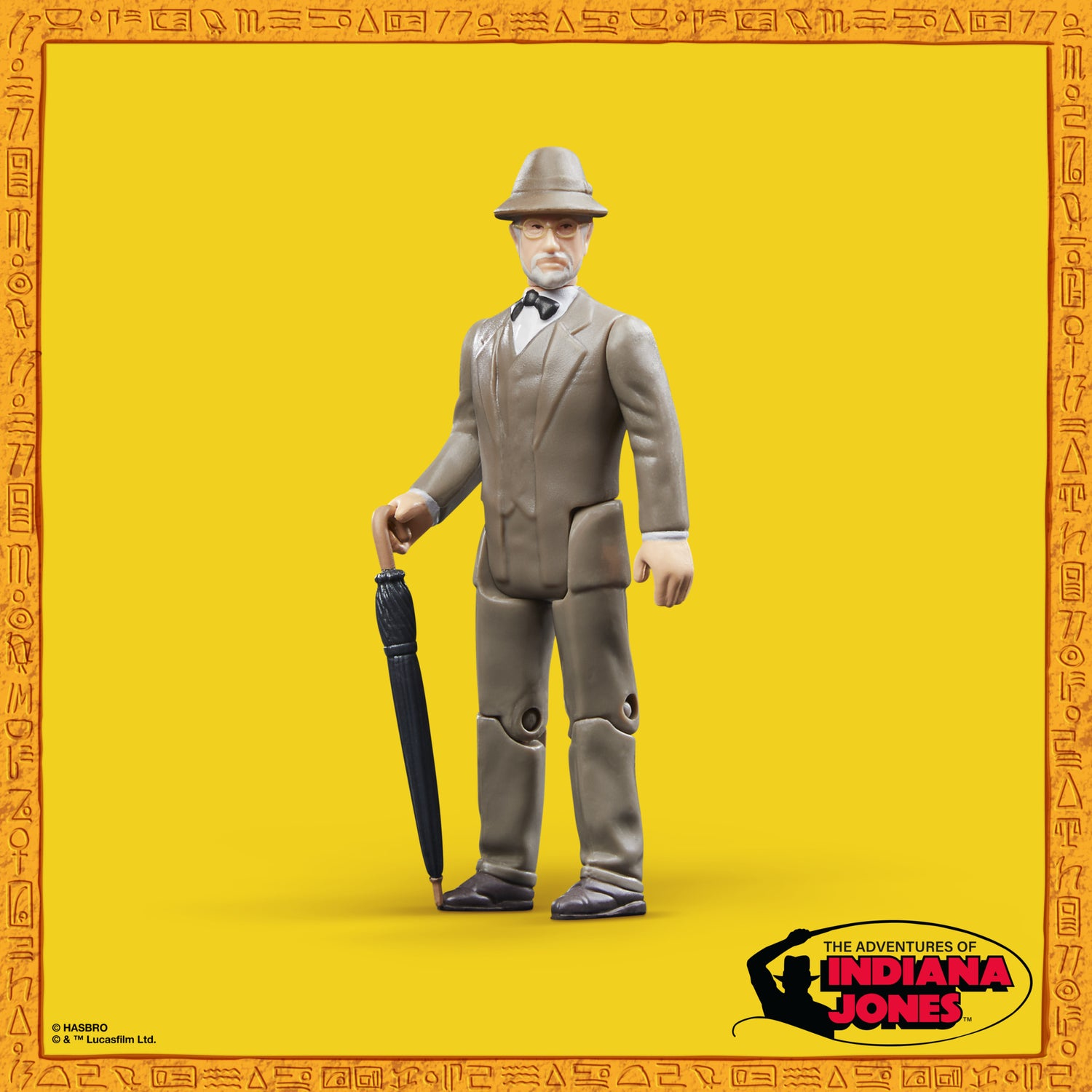 Una figura di Indiana Jones in giacca e cappello tiene un ombrello. Sfondo giallo con il logo di Indiana Jones.