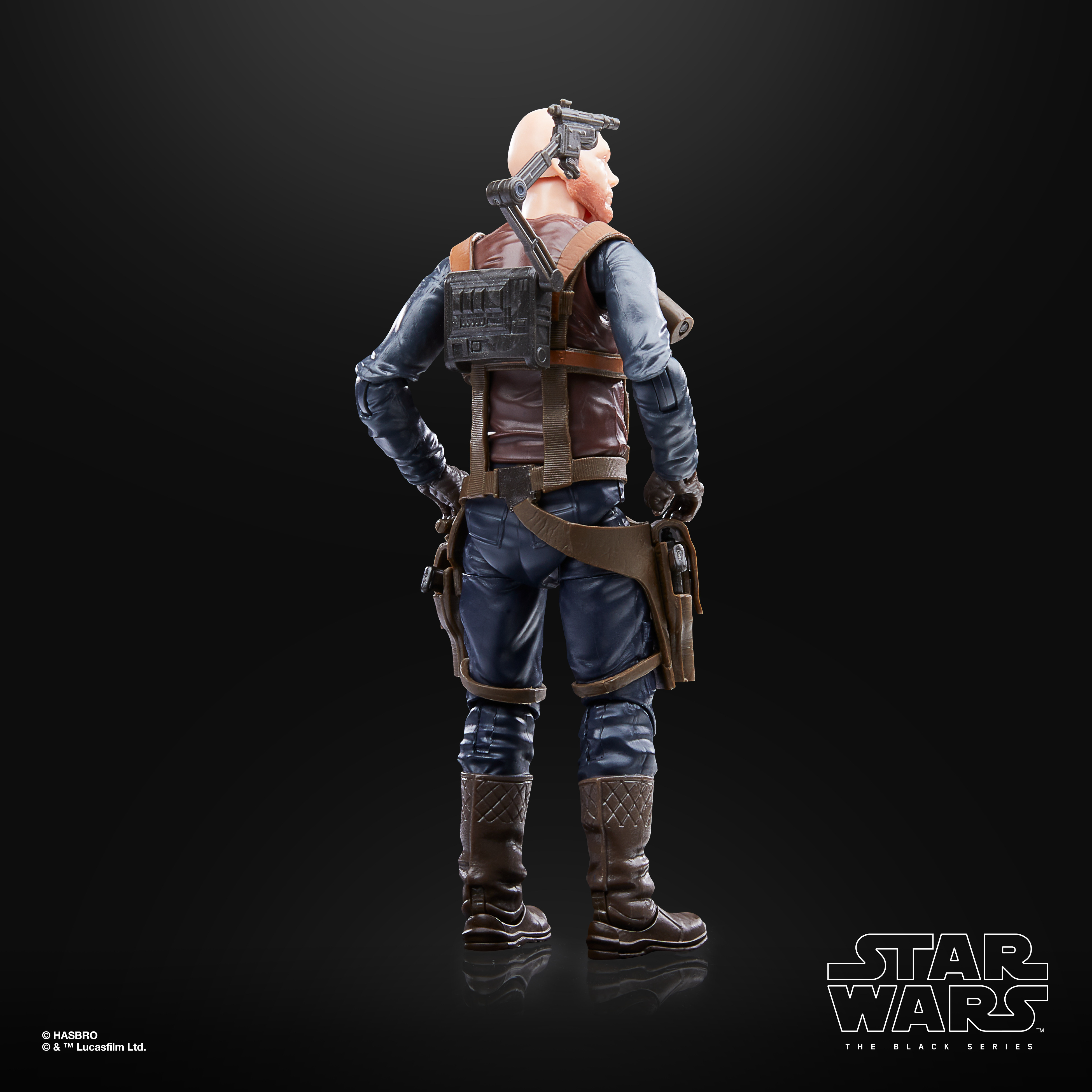 Eine Star Wars-Actionfigur, von hinten gesehen. Sie trägt blaue Hosen, braune Stiefel und eine braune Weste. Schwarzer Hintergrund.