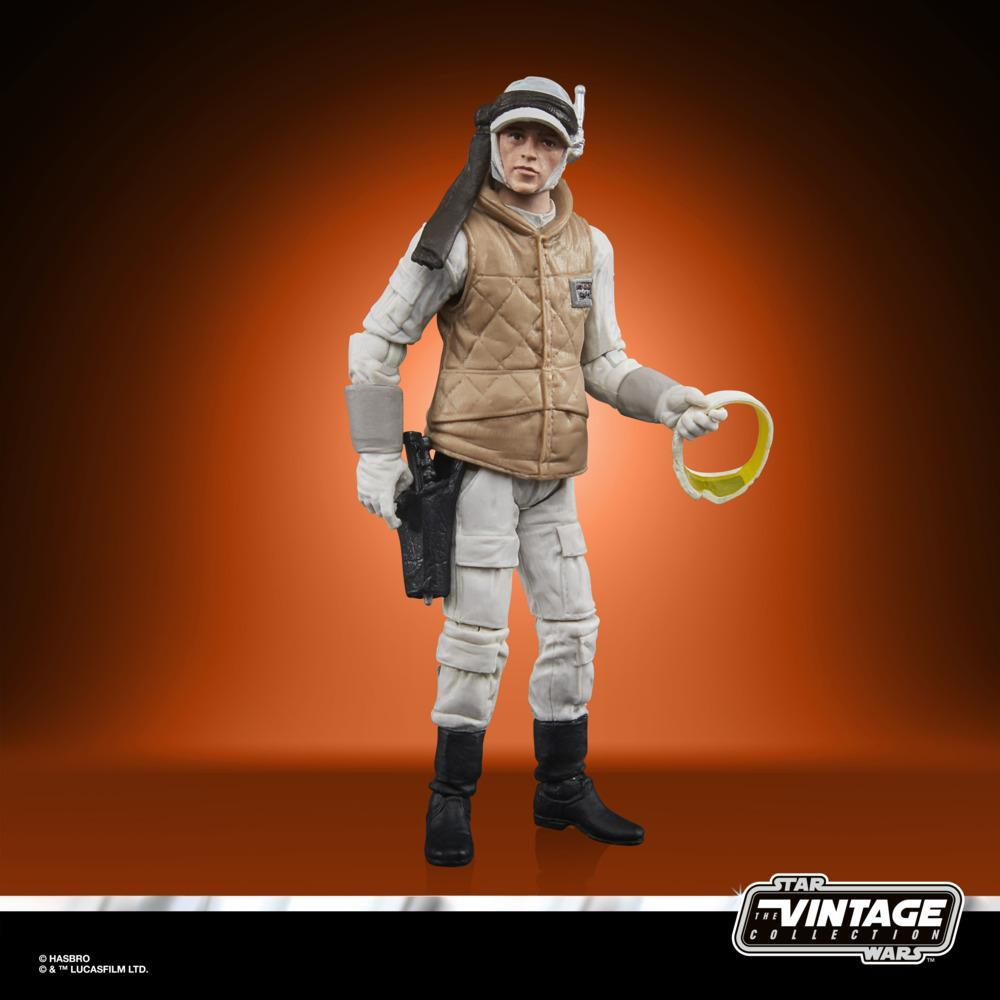 Una action figure di Star Wars, tuta bianca, gilet marrone, con occhiali. Stivali e fondina neri. Sfondo arancione con logo Star Wars.