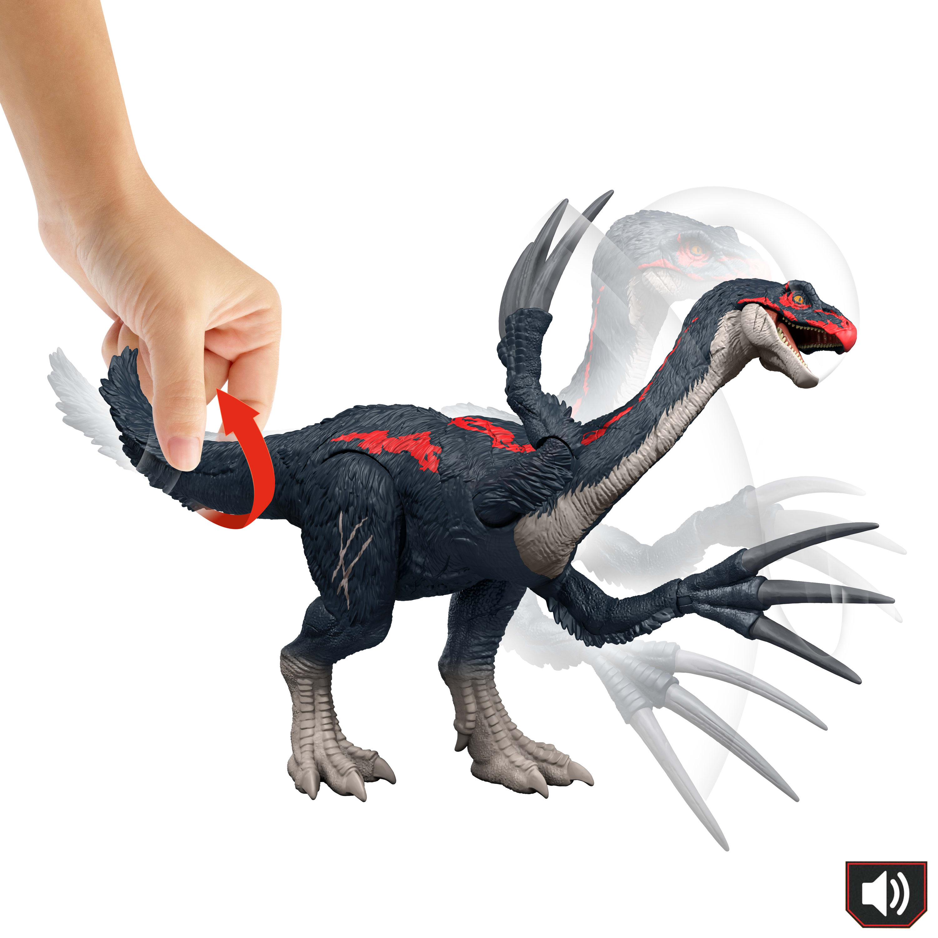 A hand turns a dinosaur toy's tail. The dinosaur is black, with red markings. It has large claws and a red head.
