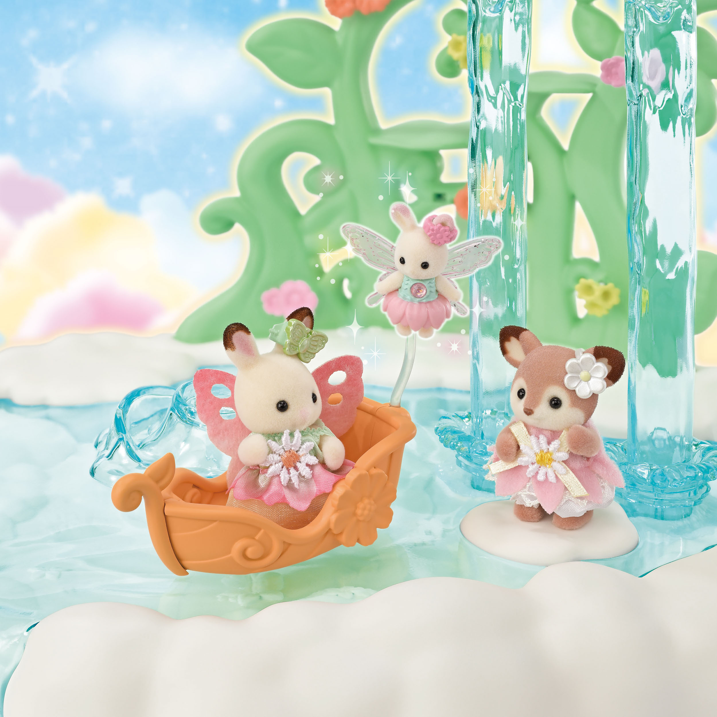 Escena con figuras de animales, hadas y un bote. Están en un entorno de fantasía con agua y flores.