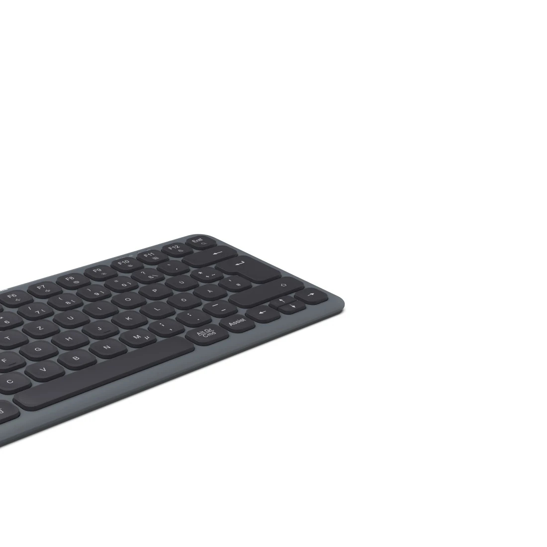 Un teclado gris oscuro se coloca diagonalmente sobre un fondo blanco. Las teclas son negras y el teclado es parcialmente visible.