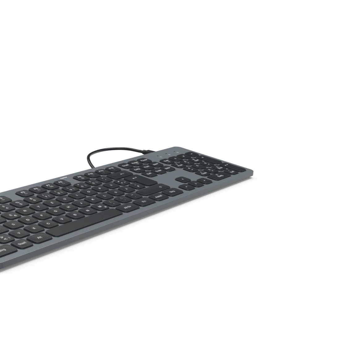 Szara klawiatura z czarnymi klawiszami leży na białej powierzchni. Czarny kabel jest podłączony do klawiatury.
