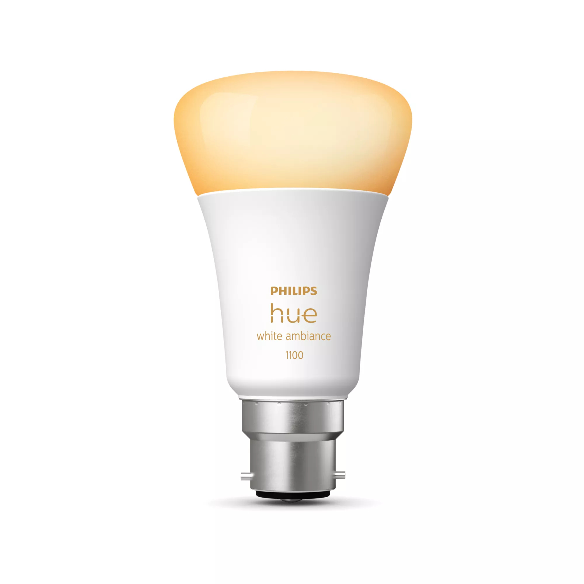 Inteligentna żarówka Philips Hue. Jest biała z żółtą poświatą na górze. Podstawa jest srebrna.