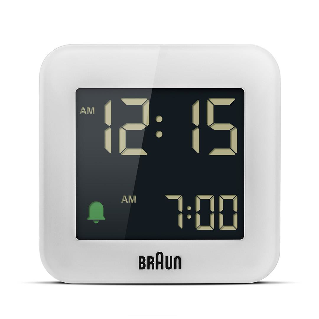Weißer Braun Wecker zeigt 12:15 AM an. Darunter 7:00 AM. Ein grünes Glockensymbol ist vorhanden. Die Uhr befindet sich auf weißem Hintergrund.