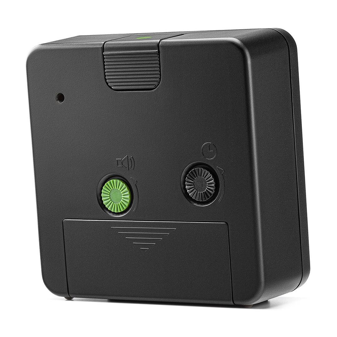 Un dispositivo negro con un botón y dial verdes. El dispositivo tiene un símbolo de altavoz, un punto pequeño y un control deslizante.