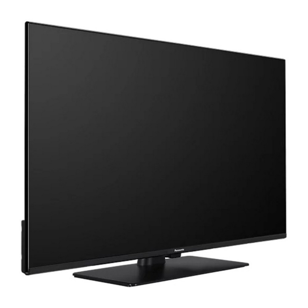Un televisor de pantalla plana grande y negro. Está sobre un soporte negro. La pantalla es oscura.