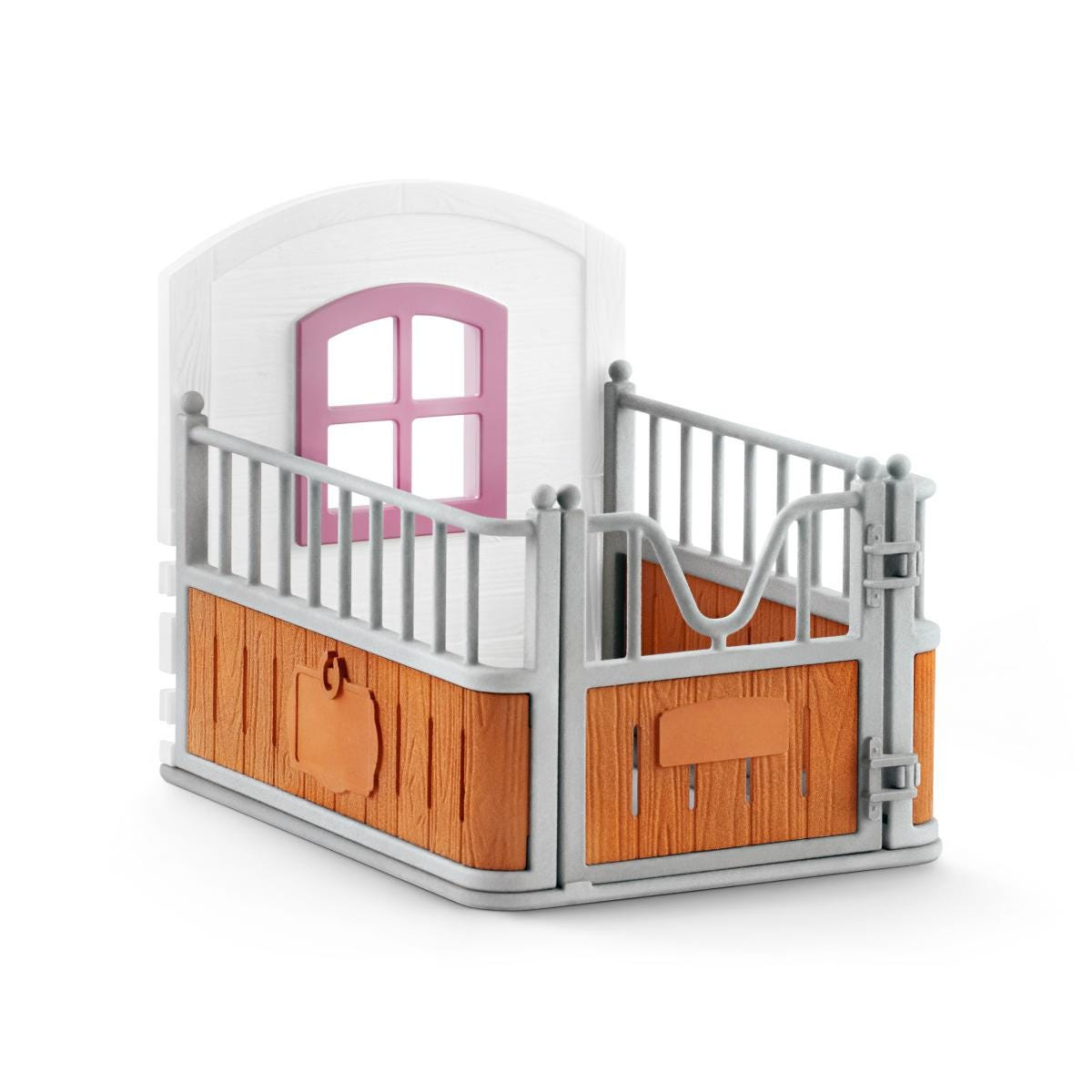 Zabawkowa stajnia z białą górną częścią i różowym oknem. Dolna część jest brązowa z szarą bramą.