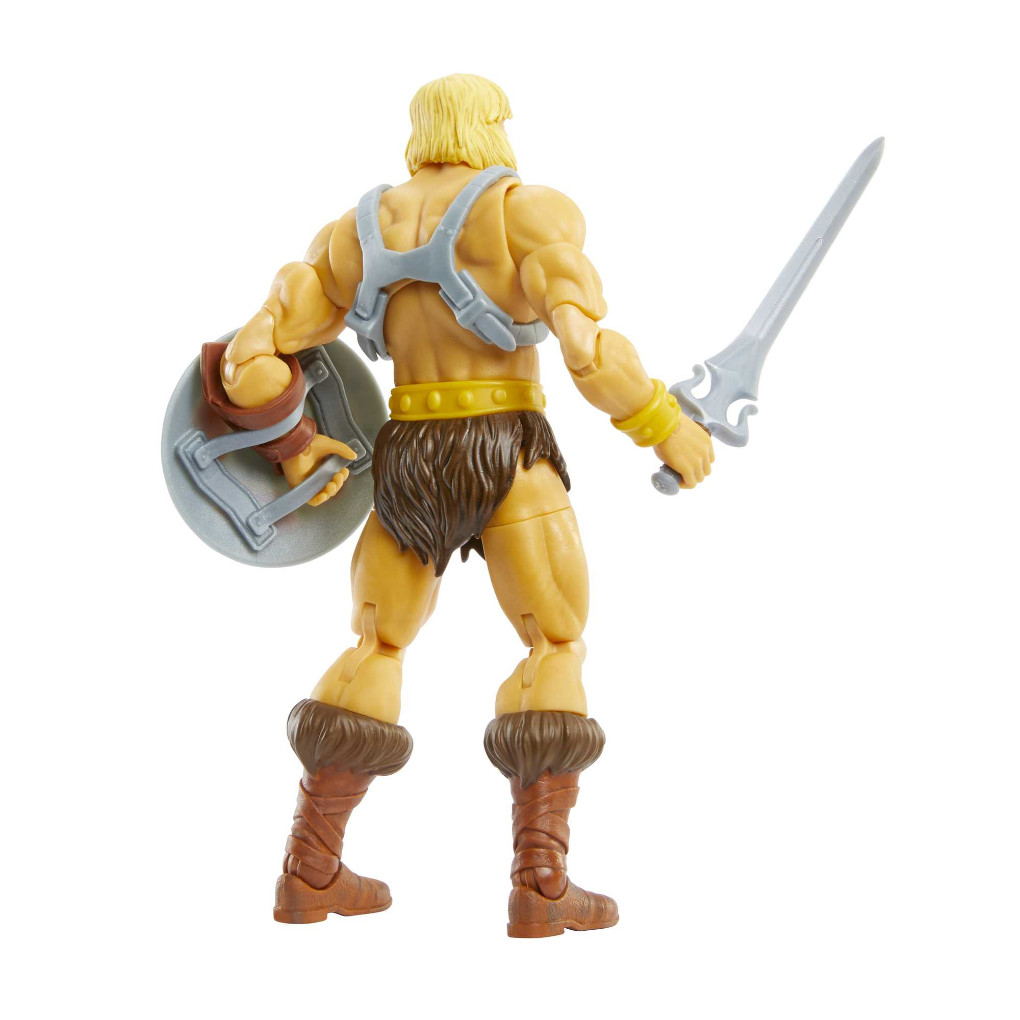 Figura de acción de He-Man, vista trasera, con espada y escudo. Pelo rubio, taparrabos peludo y botas marrones.
