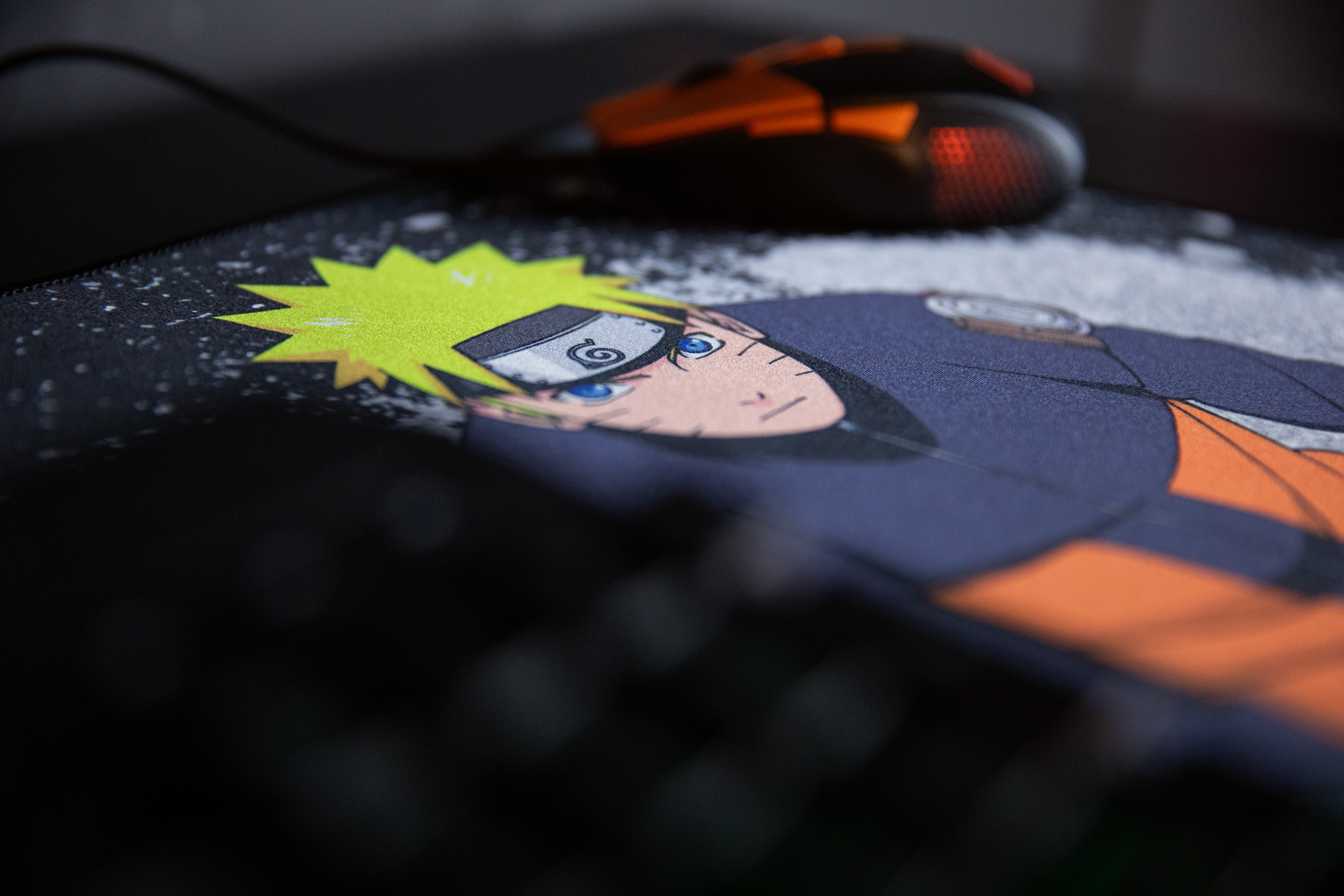 Podkładka pod mysz Naruto z pomarańczową i czarną myszą. Podkładka przedstawia wizerunek Naruto.