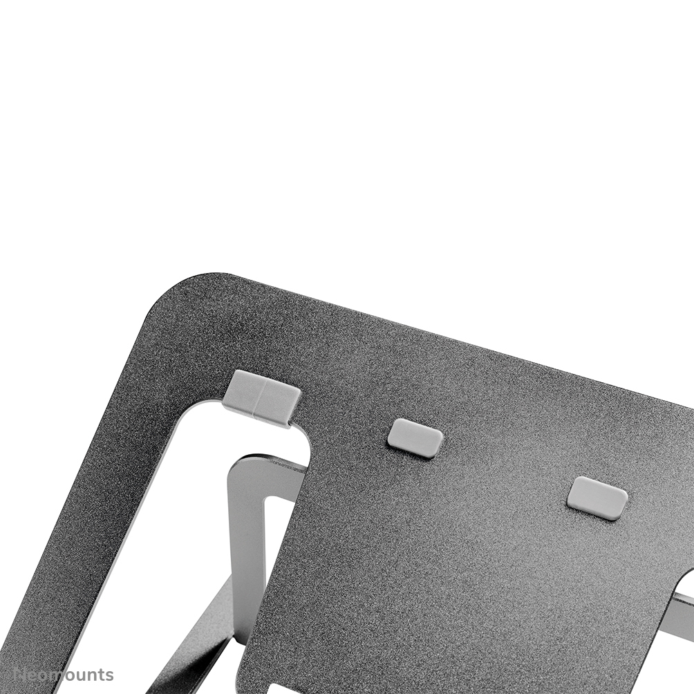 A close-up view of a silver laptop stand. It has a textured surface with grey rubber pads and a minimalist design.