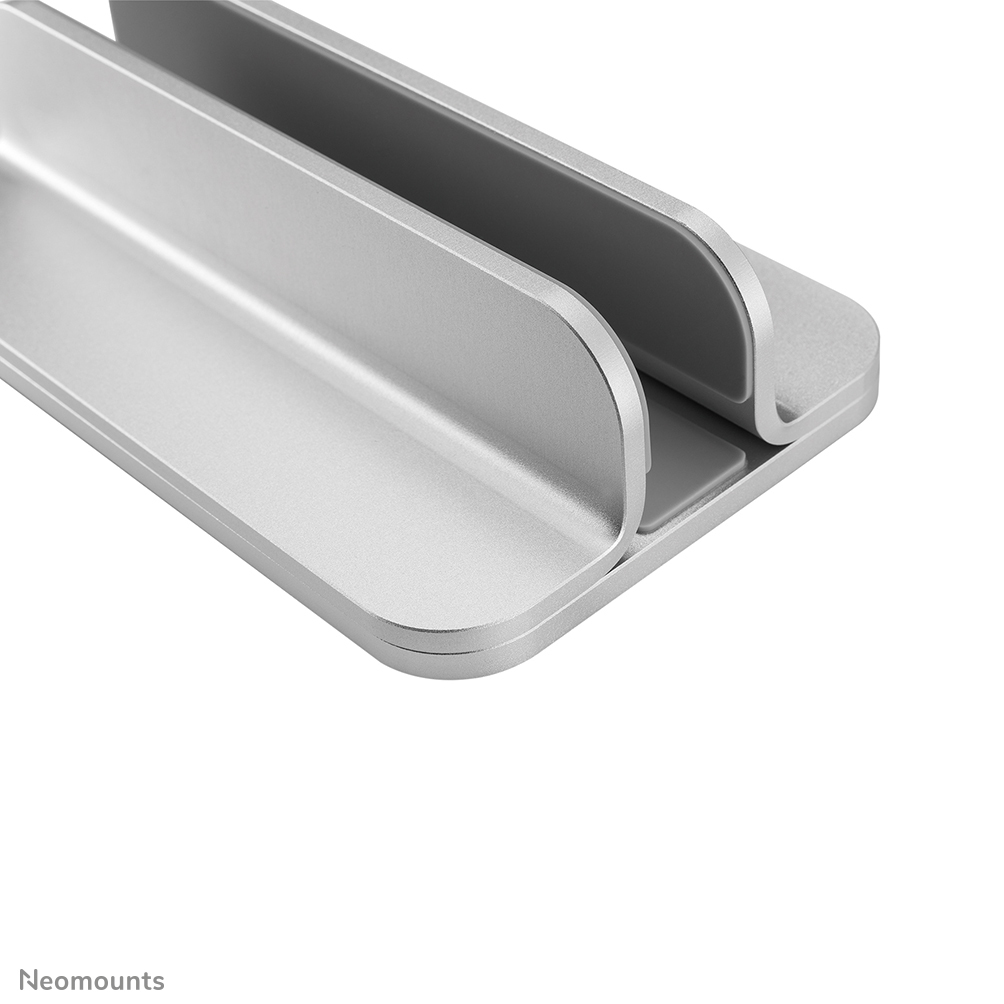 A silver laptop stand with two slots, it has a curved design and rests on a white background. It's made of metal.