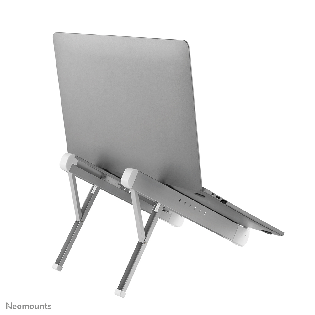 A silver laptop is on a silver and white stand. The stand is angled. The background is white.