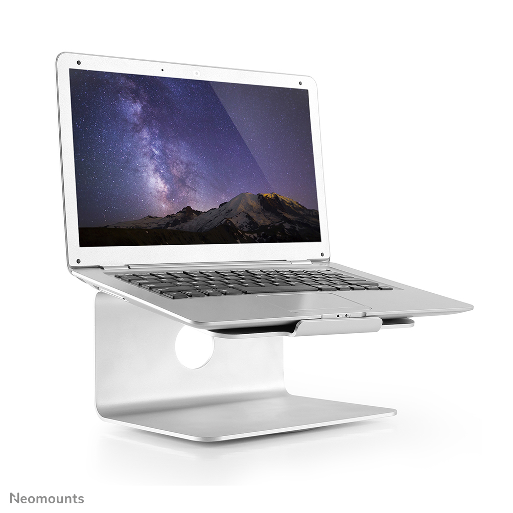 Ein silberner Laptop steht auf einem silbernen Ständer. Der Laptop-Bildschirm zeigt eine Berglandschaft mit Sternenhimmel.