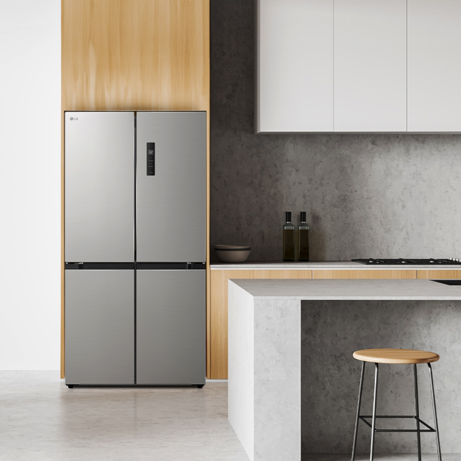Cucina moderna con frigorifero LG in acciaio inox, mobili in legno e isola in cemento con sgabello.