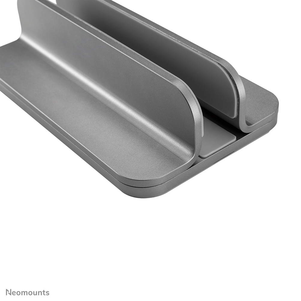 A gray, metallic laptop stand. It has two vertical supports connected to a base with a slot to hold a laptop.