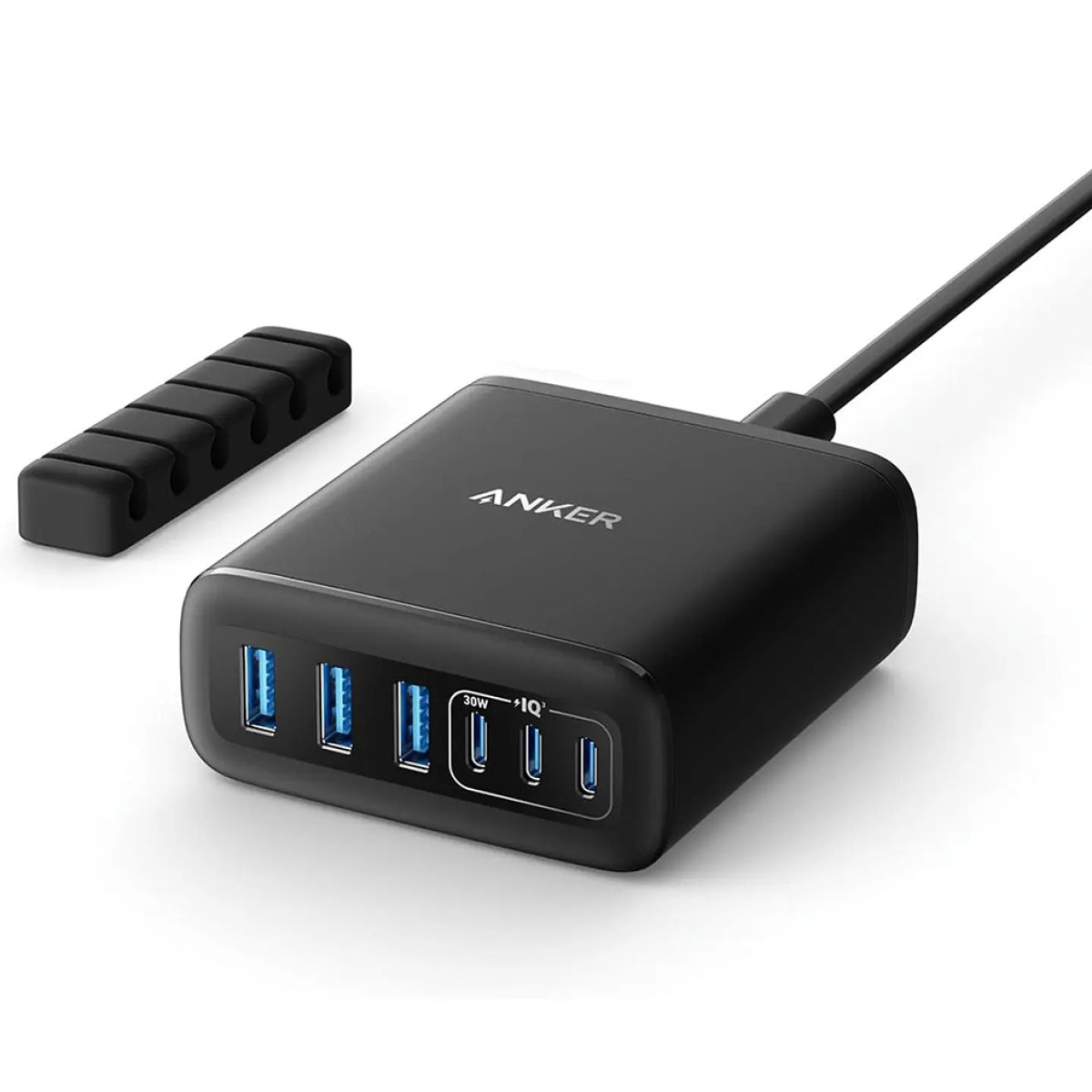 Caricabatterie USB Anker nero con più porte, un cavo e un organizzatore di cavi su sfondo bianco.