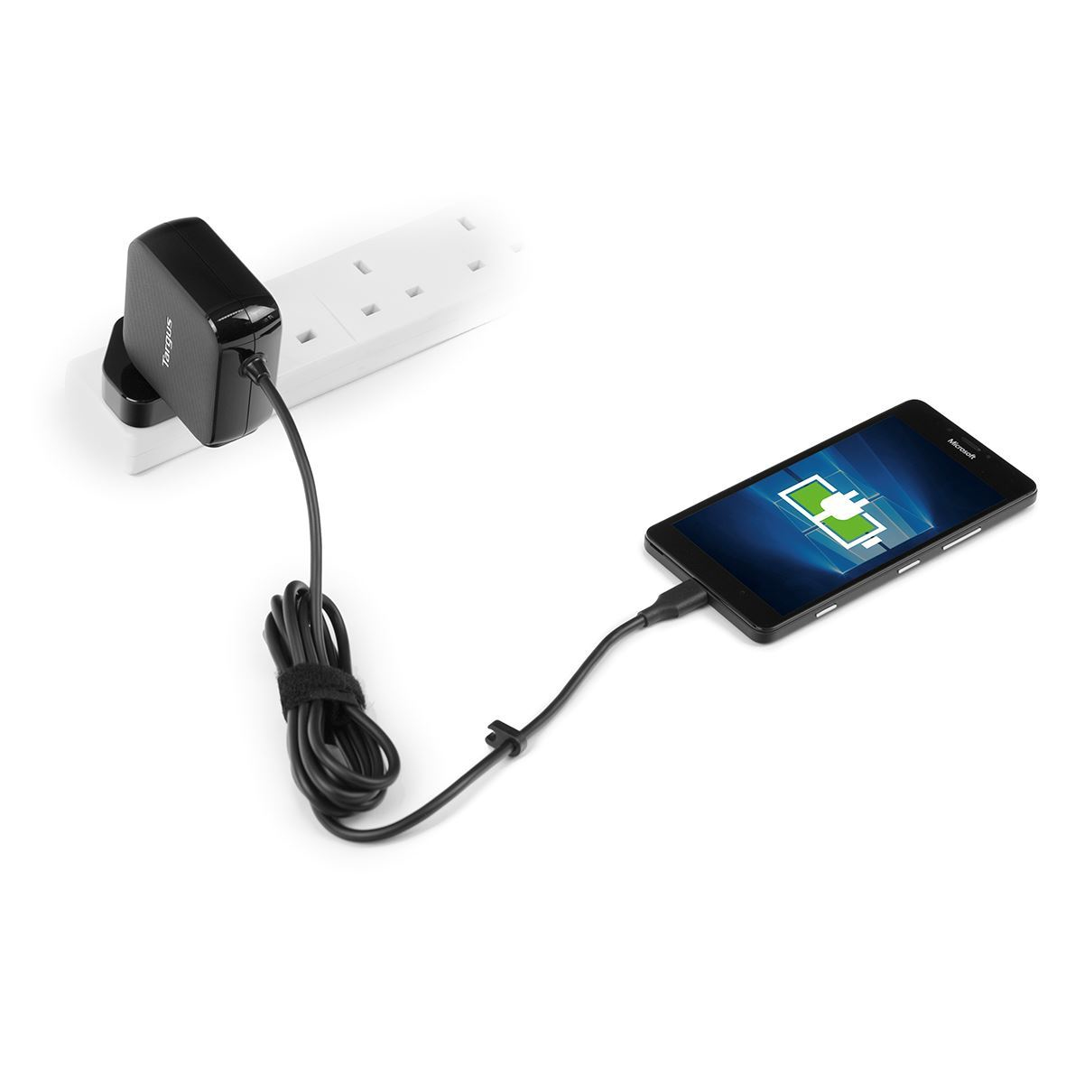 A phone charging, connected to a power outlet via a black charger and cable. The phone screen shows a charging icon.