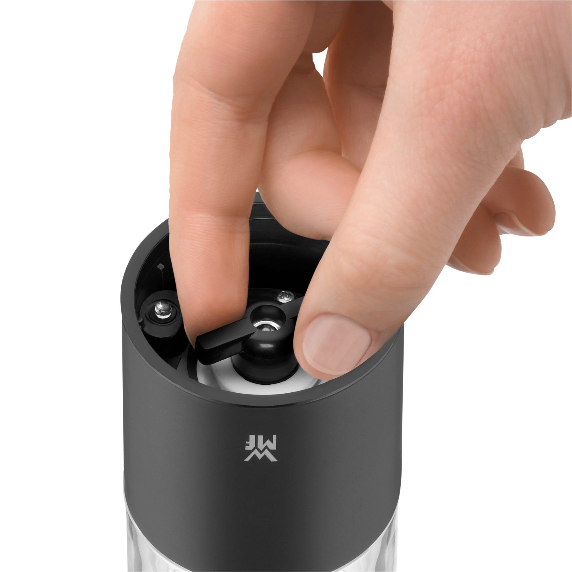 Eine Hand justiert eine schwarze Pfeffermühle. Die Finger drücken einen kleinen schwarzen Hebel.