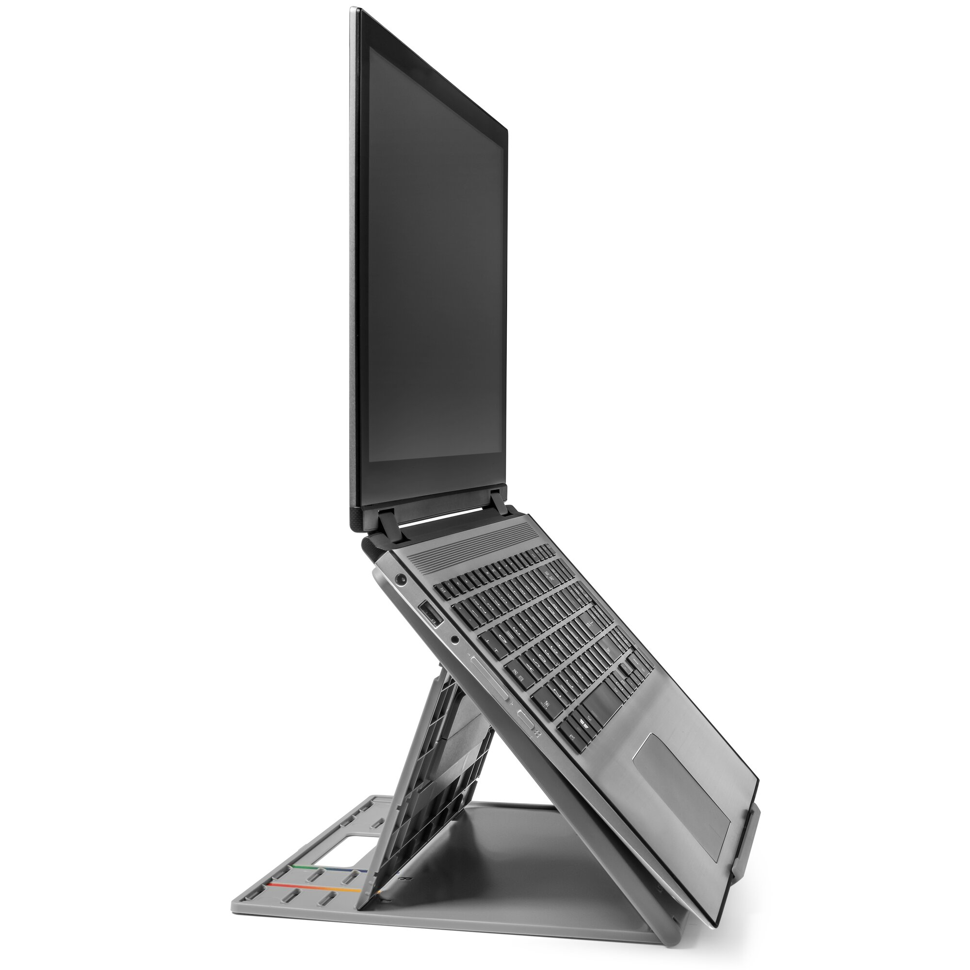 A gray laptop is propped up on a stand. The screen is open, keyboard visible, set against a white backdrop.