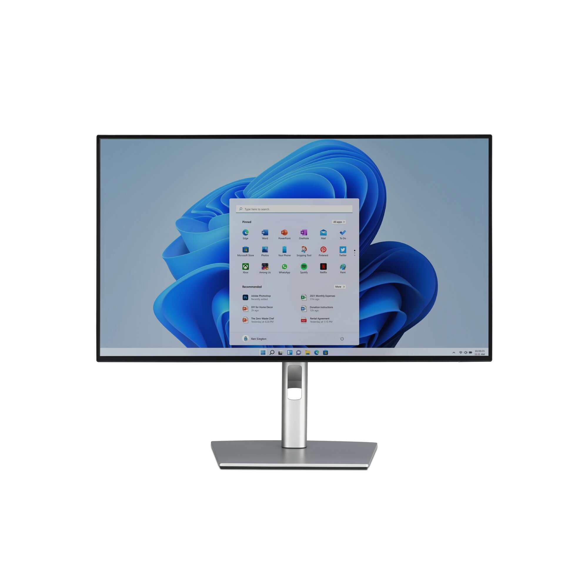 Un monitor de computadora muestra un escritorio de Windows 11. El monitor es plateado, con un borde negro, y está sobre un fondo blanco.