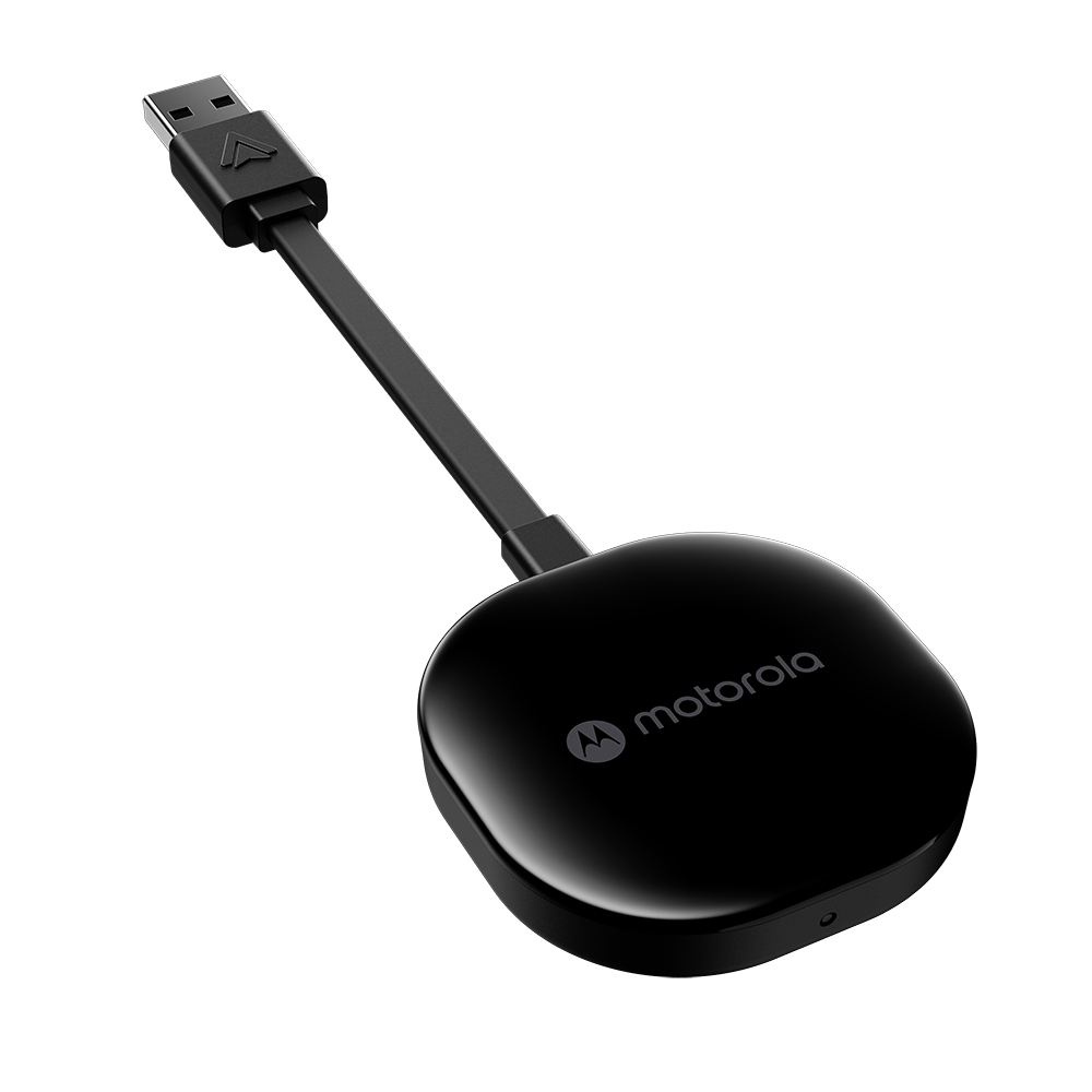 Un dispositivo Motorola negro con cable USB. El dispositivo es redondo con el logotipo de Motorola. El cable se conecta a un enchufe USB.