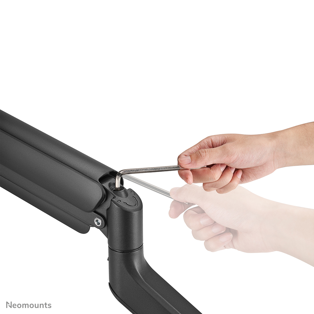A hand using a silver Allen wrench on a black monitor arm. A blurred hand mirrors the action.