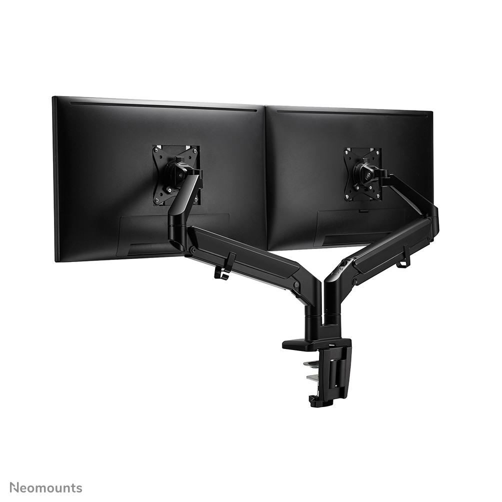 Two black computer monitors mounted on a dual-arm desk stand. The stand is black and has a clamp for attaching to a desk.